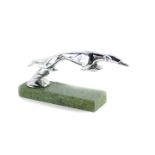 A car mascot of a leaping greyhound, after a design by Casimir Brau, raised on a marble base, 19.5cm