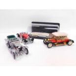 Three Franklin Mint die cast models, comprising 1910 Rolls Royce Silver Ghost., 1928 Stutz Black