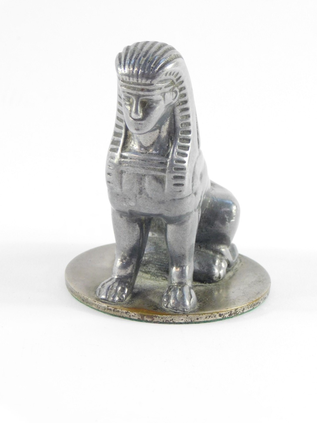 An Armstong Siddeley early 20thC aluminium coated brass car mascot, modelled as a seated sphynx,