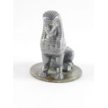 An Armstong Siddeley early 20thC aluminium coated brass car mascot, modelled as a seated sphynx,