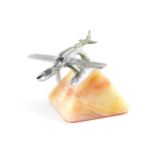 A chrome car mascot modelled as a Schneider Supermarine Seaplane, raised on a marble base, 9cm wide.