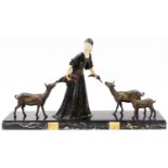 A Continental Art Deco bronzed and marble figure group, formed as a lady in flowing robes feeding