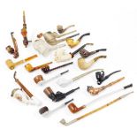 Various pipes, to include a porcelain transfer printed example with metal mounts and wooden stem,