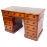A 19thC mahogany twin pedestal desk, with a one piece stencilled leather top, raised above three