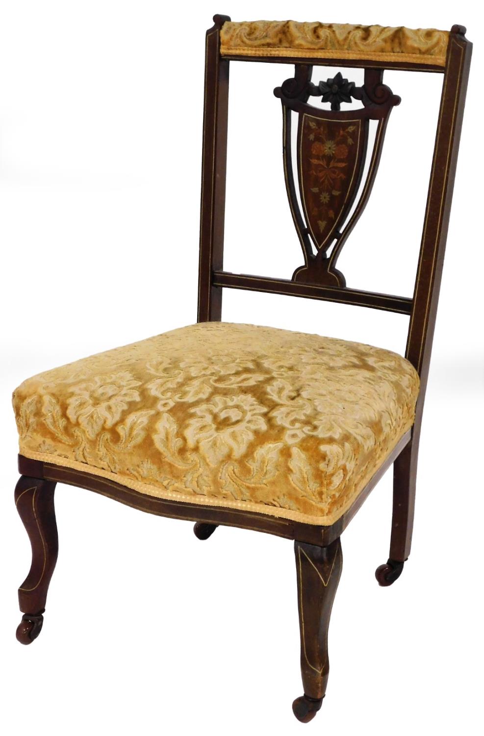 An Edwardian bedroom chair, with shield marquetry inlaid back, on gold upholstered seat, in shaped