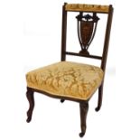 An Edwardian bedroom chair, with shield marquetry inlaid back, on gold upholstered seat, in shaped