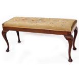 An early 20thC petit point duet stool, of rectangular form on cabriole legs, terminating in pad