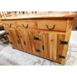 A hardwood sideboard, in the rustic style with button bordered top, three drawer top section and
