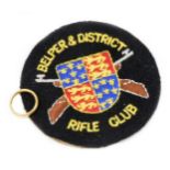 A 22ct gold wedding band, size J-K, 6.3g, and a Belper & District Rifle Club iron on badge. (2)