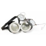 A pair of vintage airman's goggles, with leather surround and elasticated straps, each eye piece,