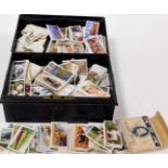 A group of Player's and other loose cigarette cards, all in black metal money tin, comprising