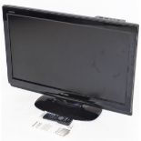 A Sharp Aquos 32" colour television, in black trim with remote control, wire and manual, LC32D44.