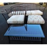 A three piece metal framed patio suite, comprising settee, armchair, and coffee table, with glass