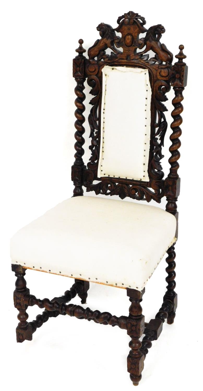 A late 19thC hall chair, with barleytwist and scroll leaf carved back and lion mask top, on