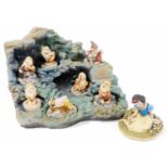 An Arden Sculptures Snow White And The Seven Dwarves set, with stand, 40cm wide.