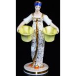 A Russian Gardner double salt figure, formed as a lady in flowing robes holding yellow salts, on a