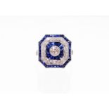 A sapphire and diamond dress ring, with chamfered edges, set with a central diamond, 4.6mm x 4.6mm x