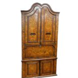 A 18thC Dutch marquetry corner cabinet, with fixed swan neck pediment, raised above heavily carved