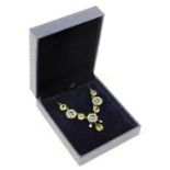 A diamond, seed pearl and peridot cluster necklace, the pendant section set with three clusters