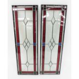 Two stained glass door panels, with red, green and blue floral boarding, with clear glass diamond