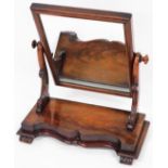 A mahogany swing framed dressing table mirror, with rectangular back plate, on scroll carved and