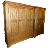 An American light oak two piece bedroom suite, comprising three door and two door wardrobes, each