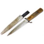 An early 20thC dagger, with plain blade marked Duisburg D L W H G, with turned wooden handle and