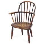 A 19thC ash and elm Windsor child's chair, raised on turned legs, 66cm high, 43cm wide, 42cm deep.