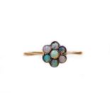 An opal daisy ring, the small daisy cluster set with an arrangement of opals, in yellow metal