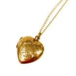 A 9ct gold pendant and chain, the 9ct gold heart shaped locket pendant florally engraved, on a