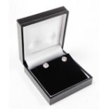 A pair of 18ct white gold diamond stud earrings, each with round brilliant cut diamond, 6.4mm x 6.