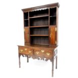 A George III oak dresser, the top with moulded cornice, fretwork frieze, three shelf design to