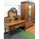 A matched Edwardian bedroom suite, comprising walnut wardrobe with single door, flanked by panels