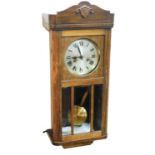 A late 19thC oak cased wall clock, with scroll carved plinth top, silvered coloured dial with