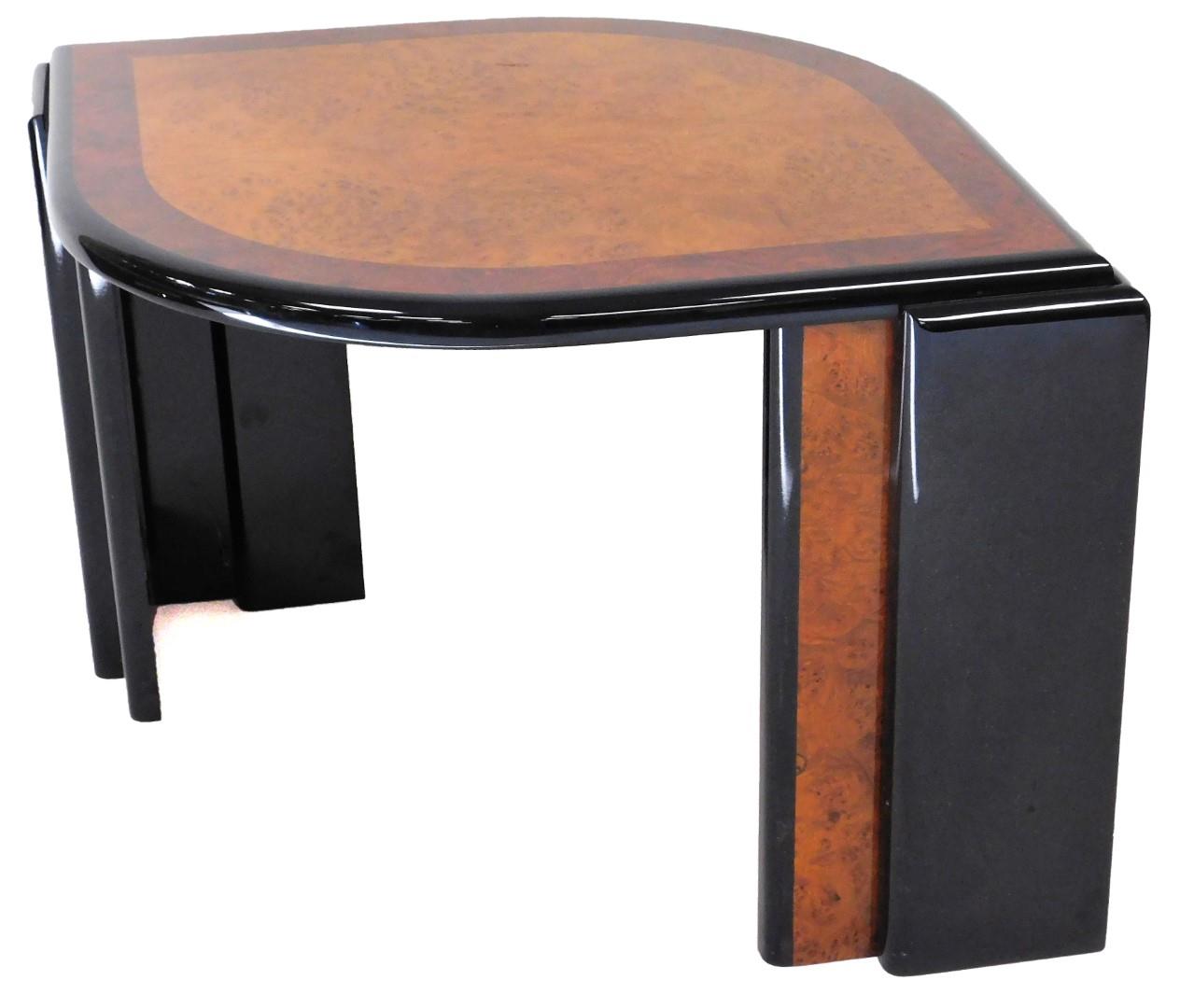 An Art Deco design coffee table, of shaped ellipse form, with a burr wood top and wide cross banding