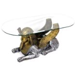 An Egyptian style coffee table, with oval bevel glass top, raised on a sphinx base, 42cm high, 102cm