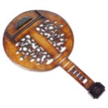 A wall decoration of a banjo, the body with floral and scroll fret carving and set with imitation