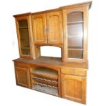 An early 20thC oak breakfront dresser, the upper section with a pair of panelled cupboards,