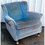 A late Victorian wing back armchair, with turned front legs, in later blue material, 95cm wide.