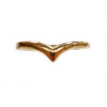 A gold coloured wishbone ring, yellow metal, unmarked.N.B. This lot is sold on behalf of the