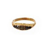 A 9ct gold dress ring, set with five white stones (one missing), with scroll edges, on a plain band,