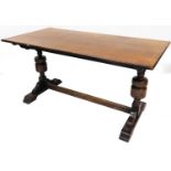 A 20thC oak refectory table, the plain rectangular top on heavy double inverted supports joined by a