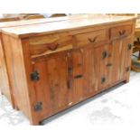 A hardwood sideboard, in the rustic style with button bordered top, three drawer top section and