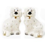 Two Royal Doulton miniature Staffordshire style Spaniels, in white with gold collars, stamped to the