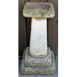 A 20thC stone bird bath, with square dish top on tapering stem and double stepped base, 75cm high,