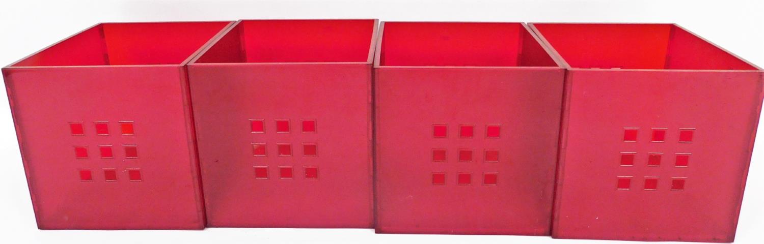 A set of four red plastic organising boxes.N.B. This lot is sold on behalf of the Rotary Club of