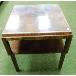 A two tier figured walnut coffee table, the top with nine square section and glass inlay, with glass