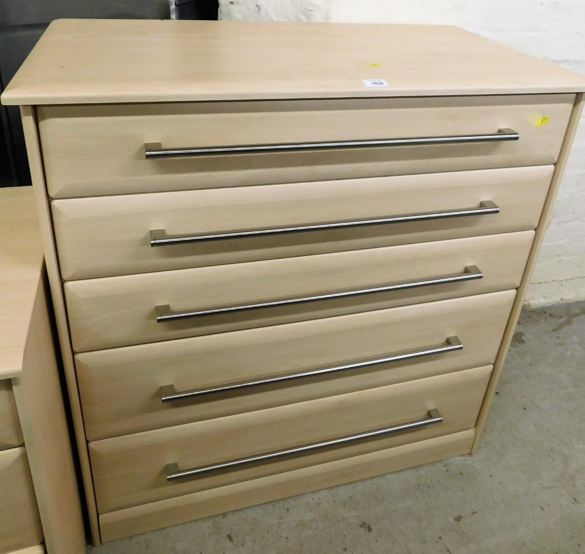 A modern chest of five drawers, with three shallow and two deep drawers, with wood finish, and