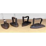 A set of four iron door stops, one bearing the emblem R, two rubbed, and another with faint