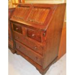 An Old Charm oak bureau, the fall section with red leather tooling, three drawers and filling